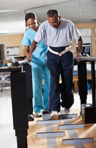 Therapist assisting a patient during walking evaluation